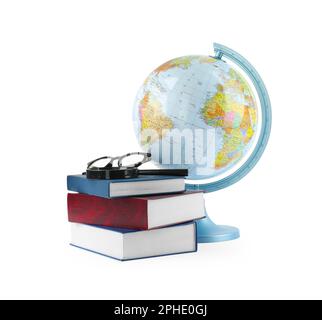 Plastic model globe of Earth, books and eyeglasses on white background. Geography lesson Stock Photo