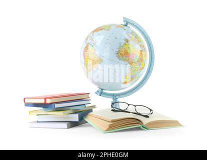 Plastic model globe of Earth, books and eyeglasses on white background. Geography lesson Stock Photo