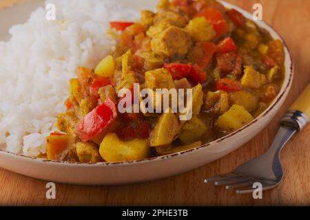 Indian styled curry with potatoes,chicken and rice. Stock Photo