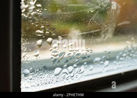 Drops of condensation on the window close-up. Humidity and temperature difference between the street and the room Stock Photo
