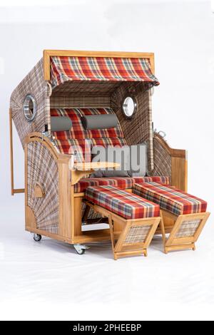 An armchair with checkered fabric and several cushions isolated on a white background. Stock Photo