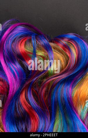 Abstract background of multicolored vibrant soft hair locks in mess Stock Photo