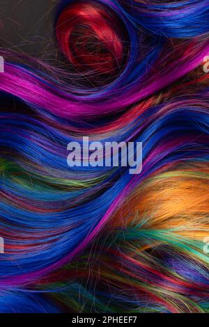 Abstract background of multicolored vibrant soft hair locks in mess Stock Photo