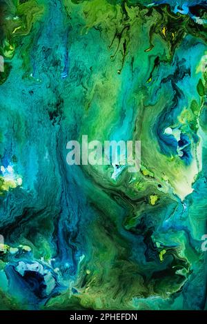 Beautiful abstraction of liquid paints in slow blending flow mixing together gently Stock Photo