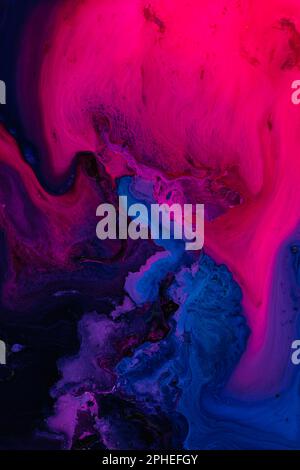 Beautiful abstraction of liquid paints in slow blending flow mixing together gently Stock Photo