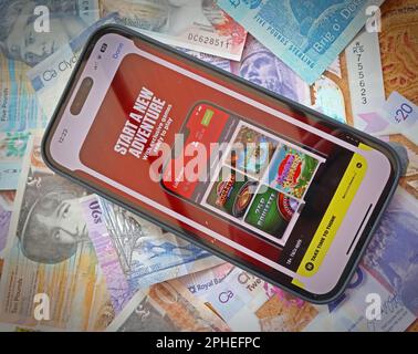 Ladbrokes Smartphone App - Online and smartphone casino, slots and gambling app with Scottish Sterling notes, money easily lost - BeGambleAware Stock Photo