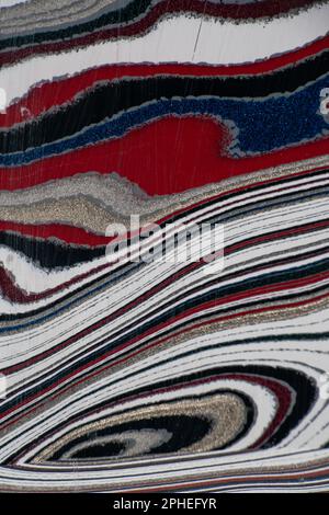 Fordite, also known as Motor or Detroit Agate, is a unique automotive enamel material with an interesting history. The original layered automotive pai Stock Photo