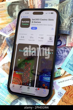 Bet365 Online and smartphone casino, slots and gambling app with Scottish Sterling notes, money easily lost - BeGambleAware Stock Photo