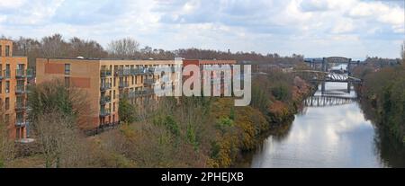 Latchford waterside housing, The Timbers, Sneha House, beside the Manchester Ship Canal, showing Knutsford Road and disused rail bridge, locks Stock Photo