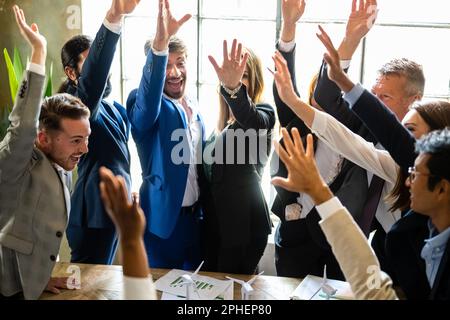 Standing Ovation, happy business people celebrating renewable energy project success at office, entrepreneur and engineers collaborating for a future Stock Photo