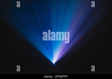 Blue and violet beams of bright laser light shining on black background Stock Photo