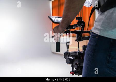 The cameraman in the studio using a professional camera with a stabilizer Stock Photo