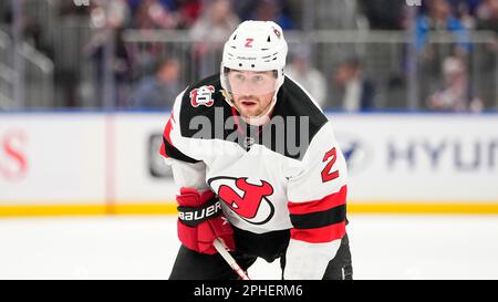 New Jersey Devils' Brendan Smith, left, argues as he is escorted