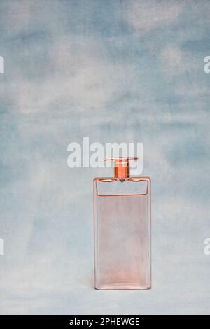 Minimalist perfume glass bottle. Transparent fragrance with steel cap. Stock Photo