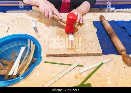 A demonstration of papyrus paper being made by a local Egyptian in Giza, Egypt Stock Photo