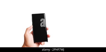 Hand holding black mobile phone isolated with blank black screen on white background with clipping path and copy space Stock Photo