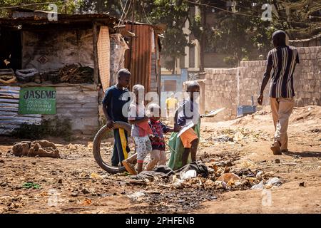 Children playing in the middle of the street in Kibera slum, Nairobi, Kenya. Kibera is the biggest slum in Africa and one of the biggest in the world. It houses an estimated population of 1 million people living in a situation of extreme poverty. A vast majority of the people lack access to basic services and medical care: only about 20% of Kibera has electricity, and the water that reaches its shacks is not clean and causes typhoid and cholera. In most of Kibera there are no toilet facilities. Unemployment rates are high and most people cannot afford education for their children. (Photo by S Stock Photo