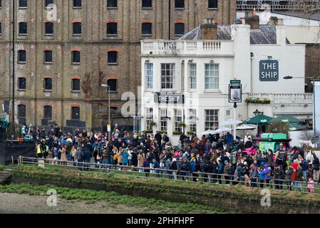 Crowds on the River Thames at Mortlake, London, UK, for the University Boat Race 2023. The Ship pub Stock Photo