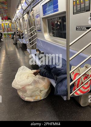 Homeless man sleeps on the seats in a New York subway car on Saturday ...