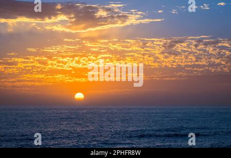 An orange and blue sunset over the Gulf of Mexico at Caspersen Beach in Venice Florida USA Stock Photo