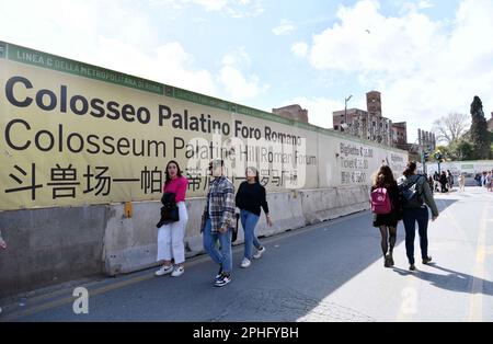 Rome, Italy. 26th Mar, 2023. People walk past tourist information in various languages including Chinese near the Colosseum in Rome, Italy, on March 26, 2023. Italy has been included on a second list of 40 destinations under a pilot program rolled out by China to resume outbound group travel. As the number of passenger flights between the two countries rebounds, more Chinese tourists are expected. Many public facilities and scenic areas in Italy now offer Chinese language services. Credit: Jin Mamengni/Xinhua/Alamy Live News Stock Photo