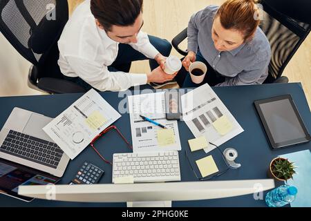 Business colleagues having video call discussing financial data working together in office. People entrepreneurs working with charts and tables on com Stock Photo