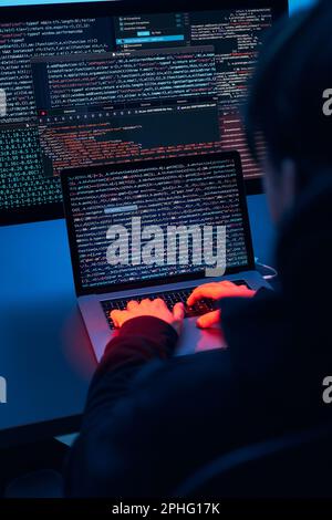 Man using computer and programming  to break code. Cyber security threat. Internet and network security. Stealing private information. Person using te Stock Photo