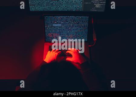 Man using computer and programming  to break code. Cyber security threat. Internet and network security. Stealing private information. Person using te Stock Photo