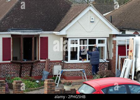 Double glazing being installed by two technicians on a residential bungalow in Shepperton Surrey England UK Stock Photo