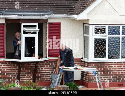 Double glazing being installed by two technicians on a residential bungalow in Shepperton Surrey England UK Stock Photo