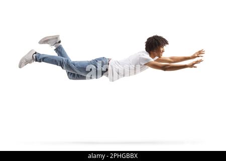 African american guy in jeans and white t-shirt flying and trying to catch something isolated on white background Stock Photo