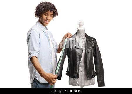 Young african american male designer measuring a jacket and smiling isolated on white background Stock Photo