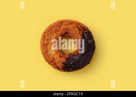 old fashioned doughnut chocolate on plate isolated on yellow background Stock Photo