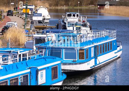 Plau Am See, Germany. 28th Mar, 2023. Passenger ships are moored in the harbor on the Elde off Lake Plaue, waiting for the start of the coming season. The number of guest arrivals and overnight stays at the Mecklenburg Lake District has increased again in 2022, but has not yet reached the pre-Corona level. Credit: Jens Büttner/dpa/ZB/dpa/Alamy Live News Stock Photo