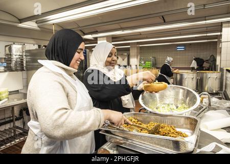 AMSTERDAM - Volunteers hand out healthy packages for the iftar in a nursing home. During the fasting month of Ramadan, Muslims eat this meal after sunset. ANP DINGENA MOL netherlands out - belgium out Stock Photo