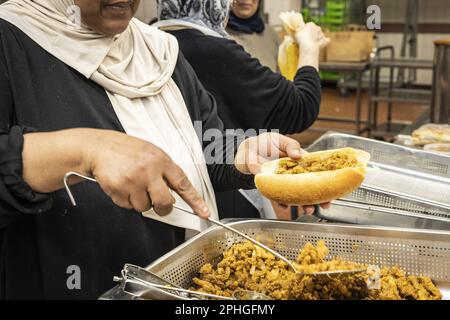 AMSTERDAM - Volunteers hand out healthy packages for the iftar in a nursing home. During the fasting month of Ramadan, Muslims eat this meal after sunset. ANP DINGENA MOL netherlands out - belgium out Stock Photo