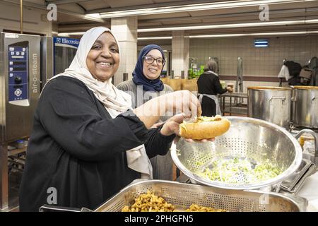 AMSTERDAM - Volunteers hand out healthy packages for the iftar in a nursing home. During the fasting month of Ramadan, Muslims eat this meal after sunset. ANP DINGENA MOL netherlands out - belgium out Stock Photo