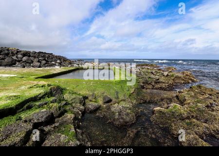 Sao Vicente Wells is a sea pool, naturally fed and bounded by basaltic rocks, located in the north side of Sao Miguel island in the Azores, Portugal Stock Photo