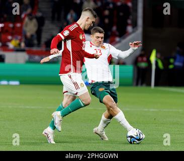 BUDAPEST, HUNGARY - MARCH 27: Roland Sallai of Hungary challenges Yoan Stoyanov of Bulgaria during the UEFA EURO 2024 qualifying round group B match between Hungary and Bulgaria at Puskas Arena on March 27, 2023 in Budapest, Hungary. Stock Photo