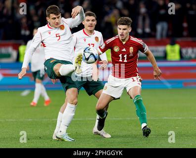 BUDAPEST, HUNGARY - MARCH 27: Plamen Galabov of Bulgaria fights for the possession with Milos Kerkez of Hungary in front of Ivan Yordanov of Bulgaria during the UEFA EURO 2024 qualifying round group B match between Hungary and Bulgaria at Puskas Arena on March 27, 2023 in Budapest, Hungary. Stock Photo