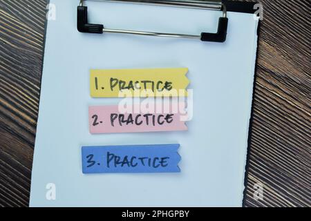 Concept of Practice, Practice, Practice write on sticky notes isolated on Wooden Table. Stock Photo