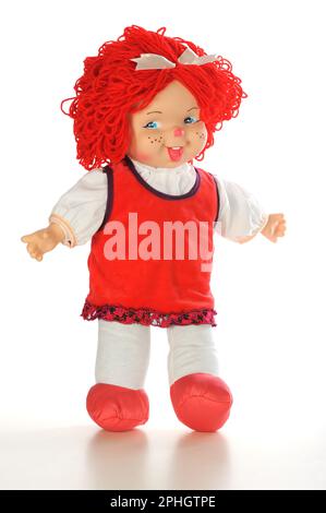 rag doll girl with redhair in a red jumpsuit suit isolated on white background Stock Photo