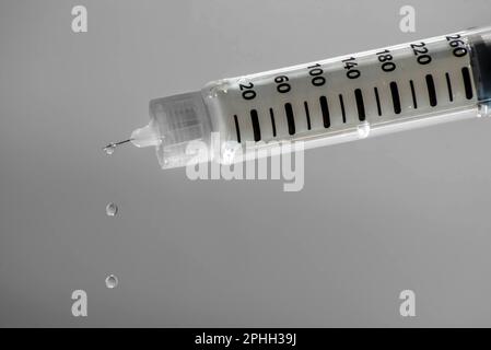 Prefilled insulin pen to treat diabetes with drops falling from the needle. Health care concepts. Stock Photo