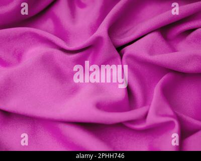 A magenta wrinkled fabric texture background. Close up. Stock Photo