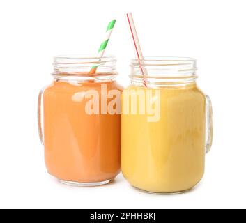 Mason jars of different tasty smoothie with straws on white background Stock Photo