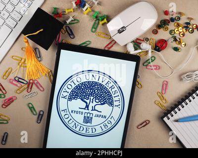 In this photo illustration, Kyoto University  logo seen displayed on a tablet. Stock Photo