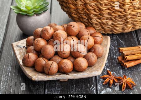 macadamia nut on wood background Stock Photo