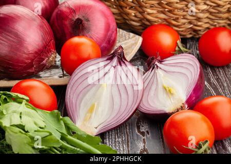 sliced red onions on wood background Stock Photo