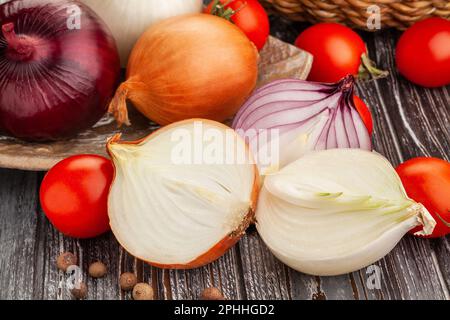 sliced colorful onions on wood background Stock Photo