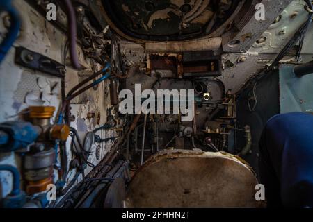View of the inside of an abandoned tank; Rusty tank pilot cabin texture Stock Photo